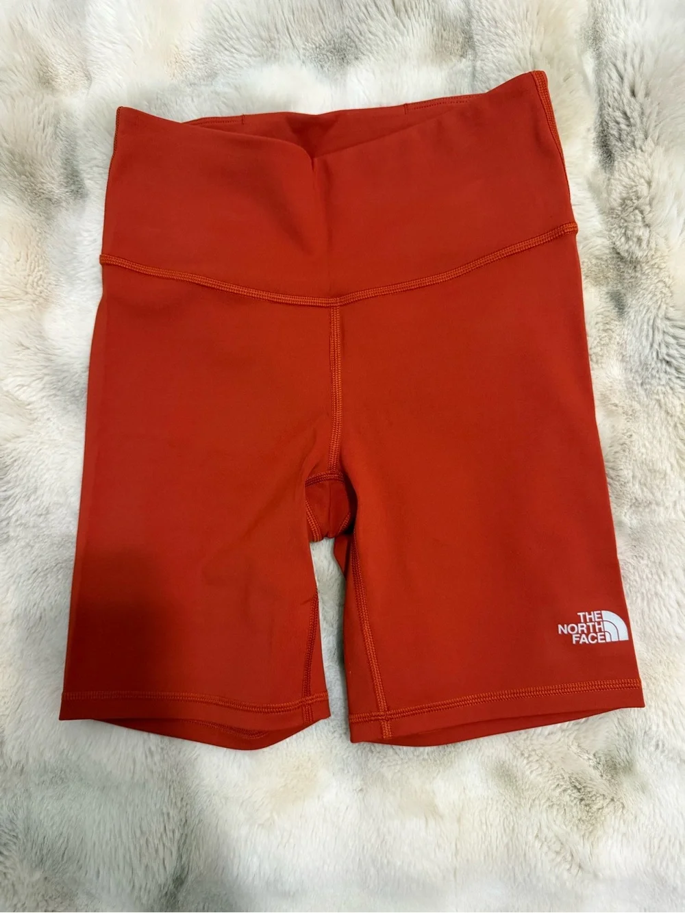 The North Face women’s athletic shorts in a beautiful orange/rust color